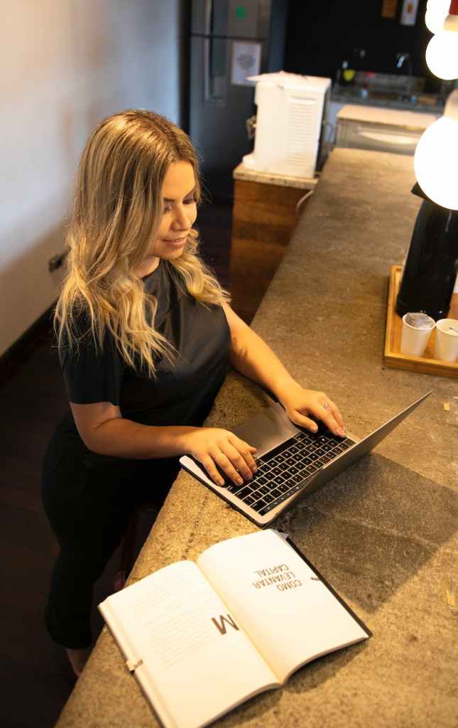blonde woman sitting with laptop