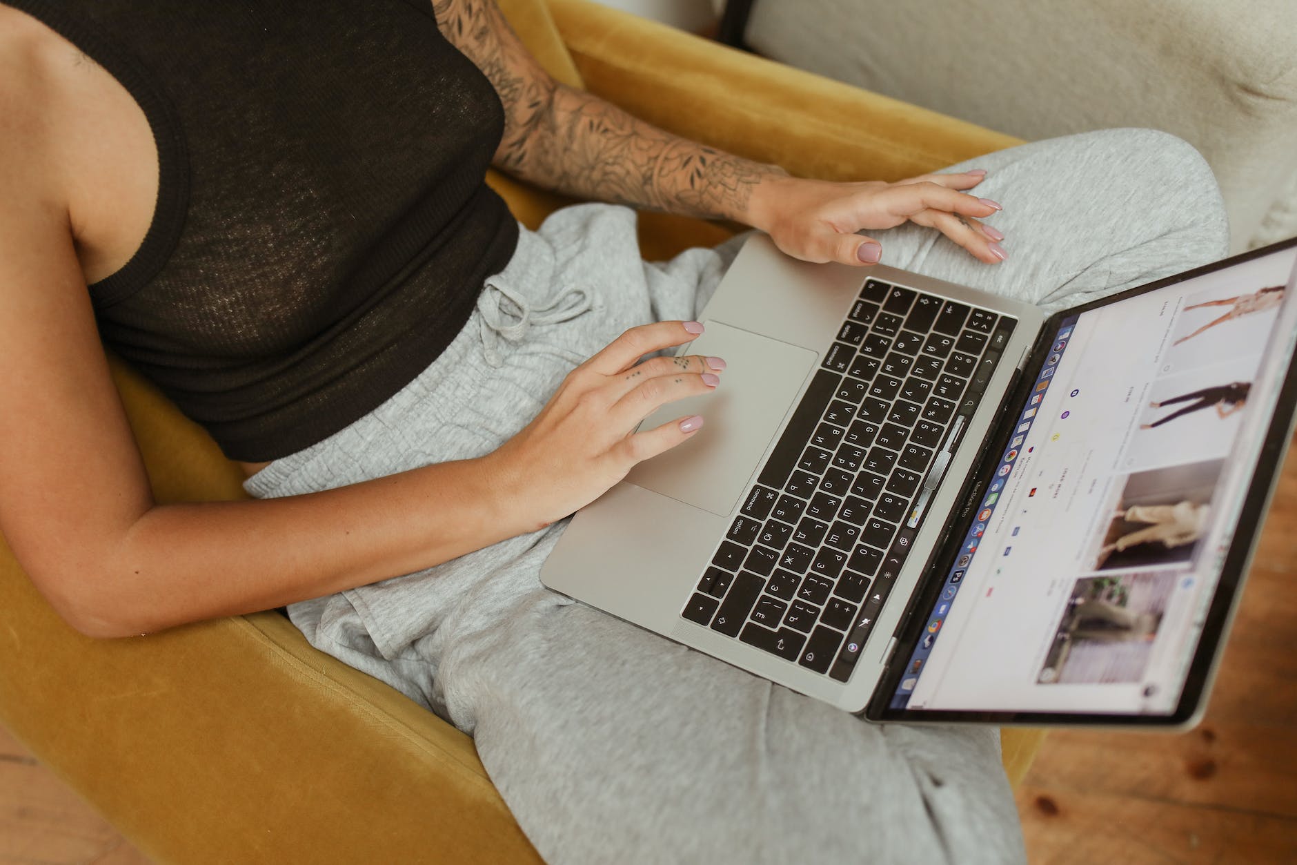 a person in black tank top using laptop