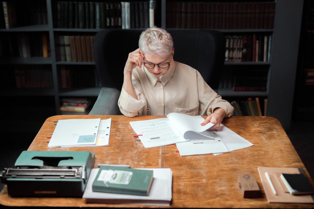 man in brown coat sitting at the table