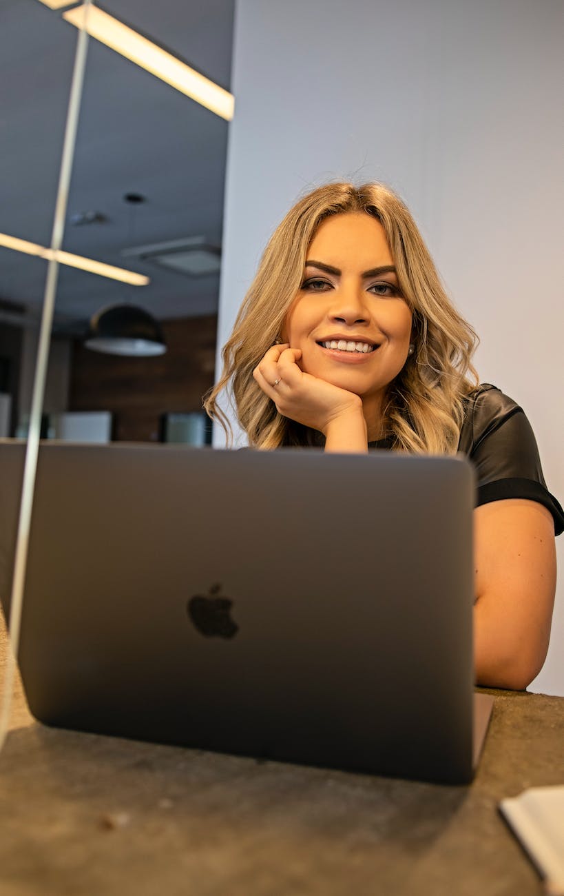 young woman using a laptop and smiling