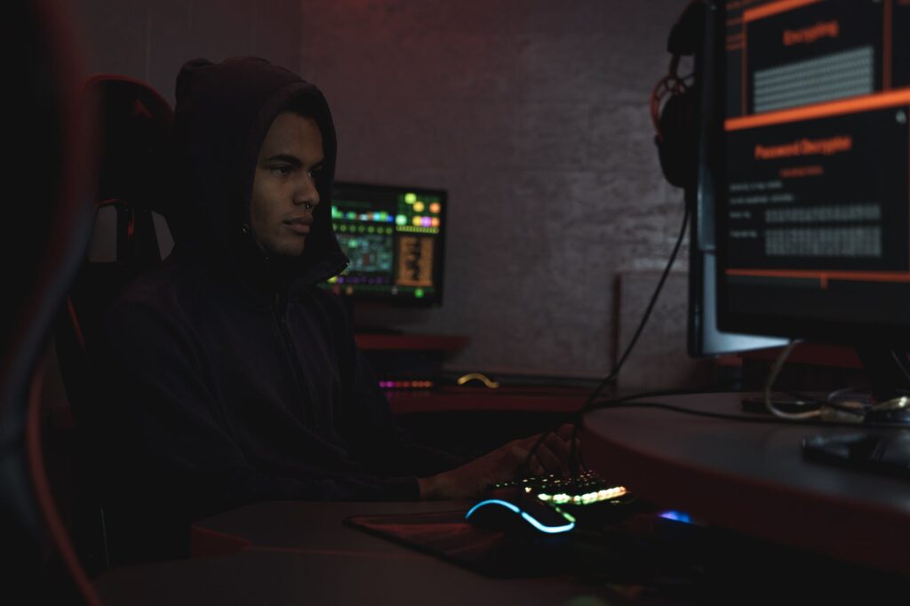 man in black hoodie using a computer