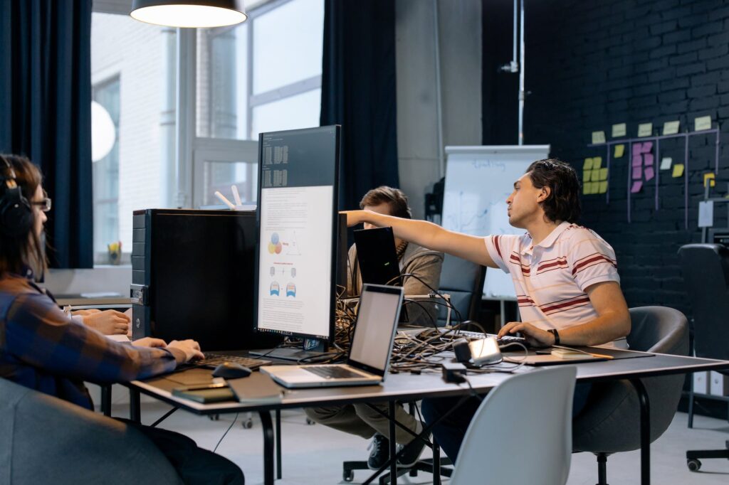 people sitting at the table with computers