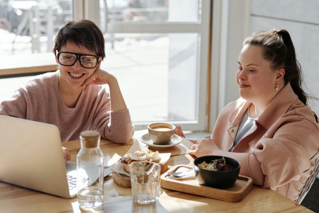 happy young people watching on a laptop