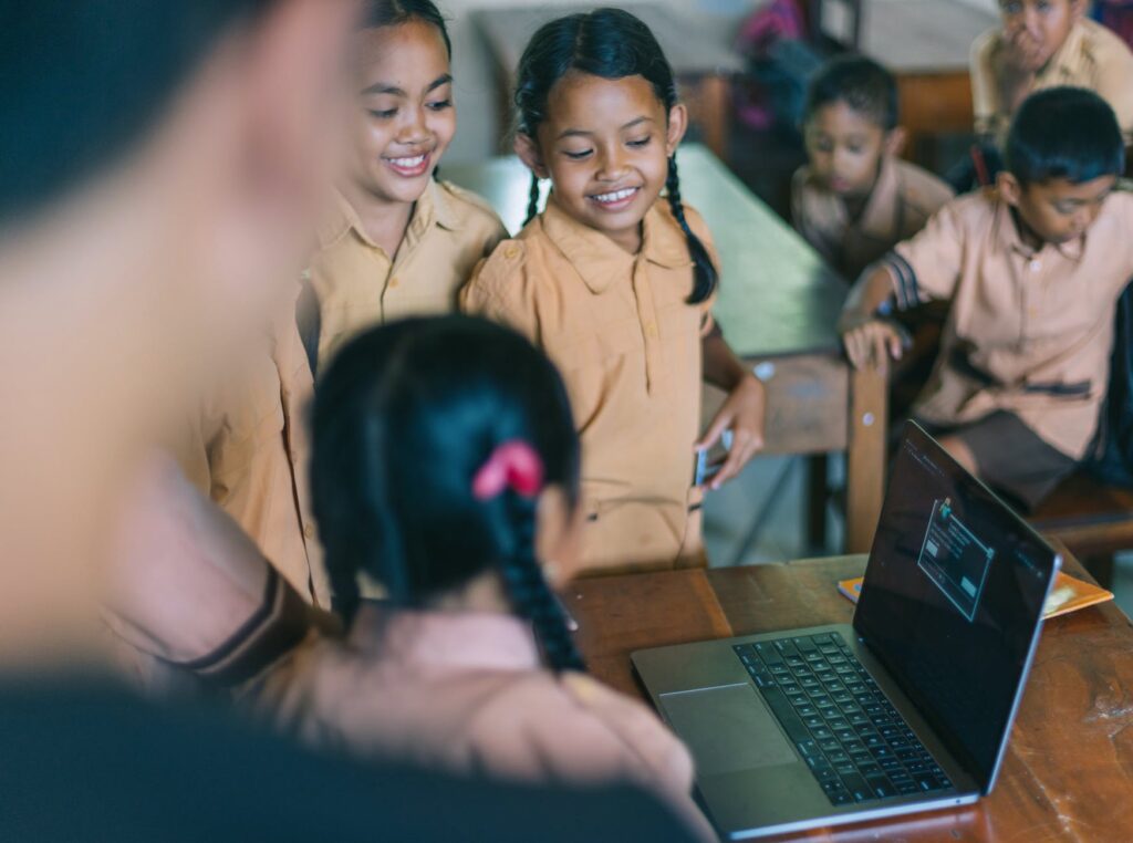 students standing beside the wooden table