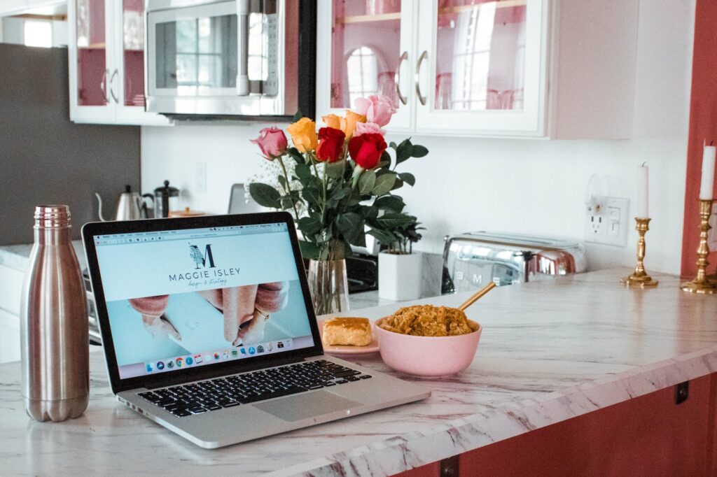 open laptop and food on the kitchen counter