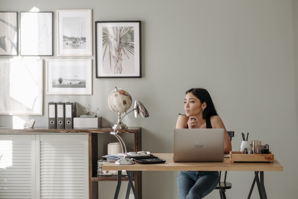 woman in black tank top using macbook