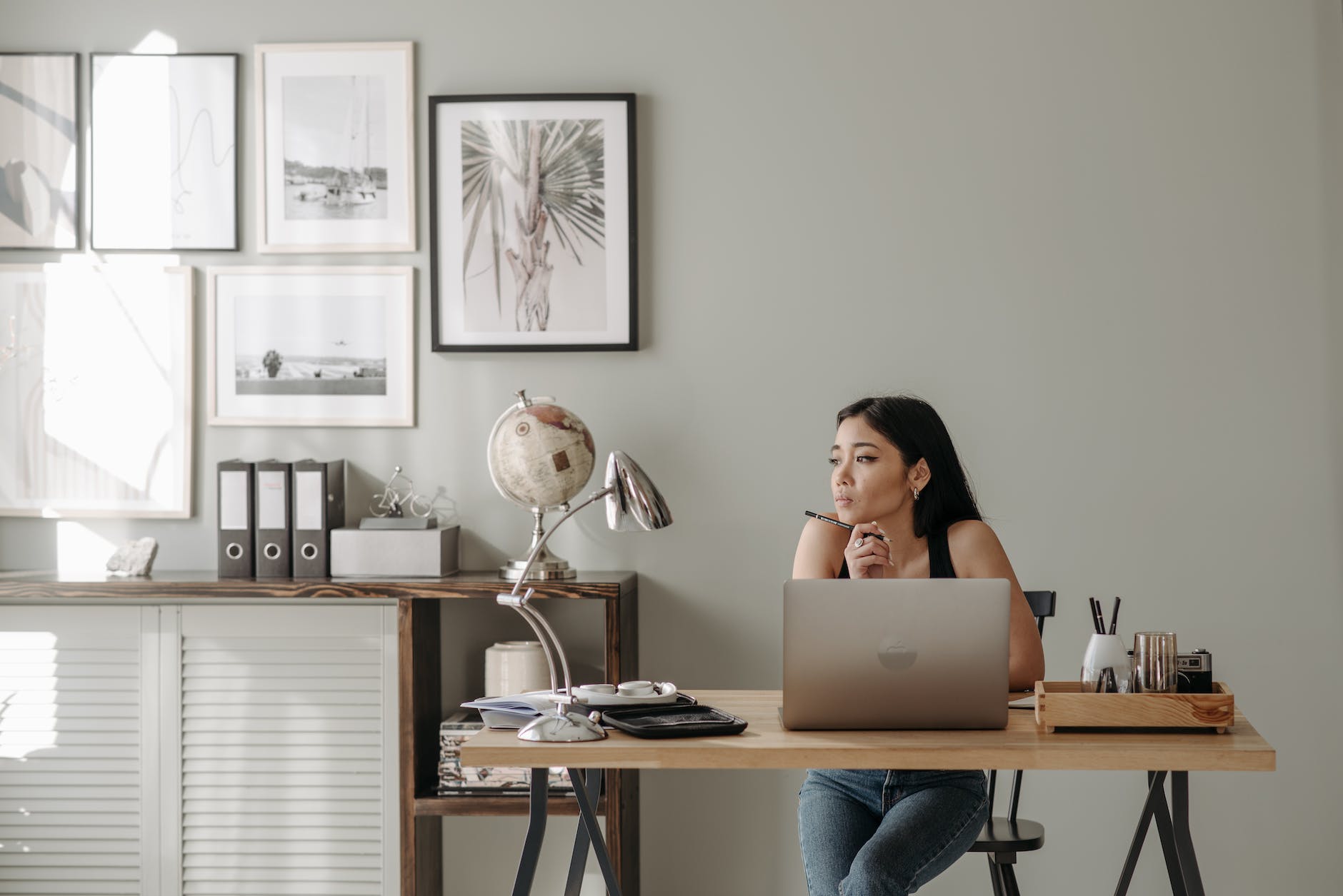 woman in black tank top using macbook